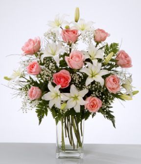 arreglo de rosas y lirios en florero